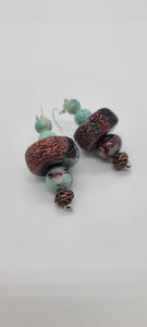 Length: 2.75 inches | Weight: 1 ounce  Distinctly You! These earrings are made with seafoam green and copper beads, black lava stone rondelles, 12mm seafoam and brown ceramic, 8mm and 10mm seafoam marble glass beads, and 8mm copper twisted charm.