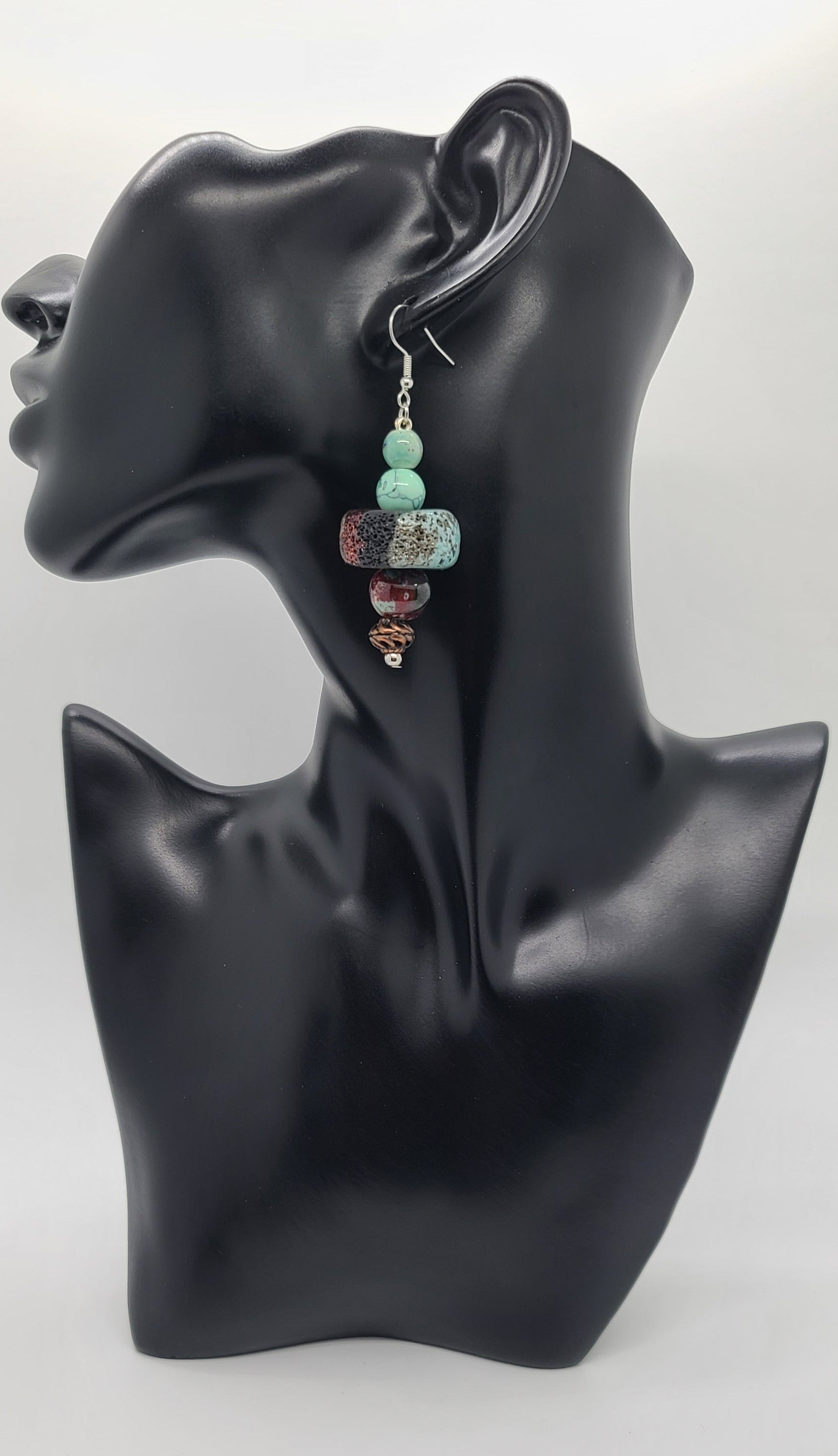 Length: 2.75 inches | Weight: 1 ounce  Distinctly You! These earrings are made with seafoam green and copper beads, black lava stone rondelles, 12mm seafoam and brown ceramic, 8mm and 10mm seafoam marble glass beads, and 8mm copper twisted charm.