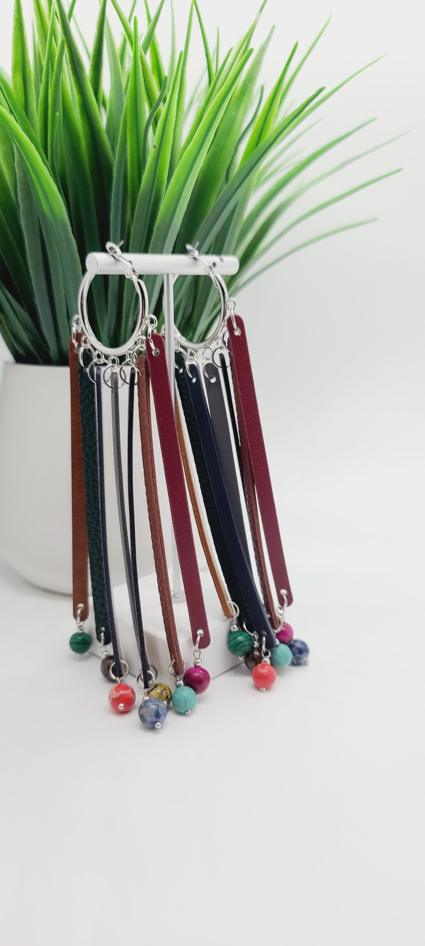 Length: 6 inches | Weight: 1 ounce  Distinctly You! These earrings are made with silver hoops, faux leather tassels, 10mm gem stones.