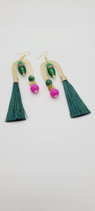 Length: 4.5 inches | Weight: 0.8 ounces  Distinctly You! These earrings are made with gold U-shape charms, green lampwork glass beads, 10mm hot pink resin beads, 8mm green Agate beads, gold tree charms, and green tassels.