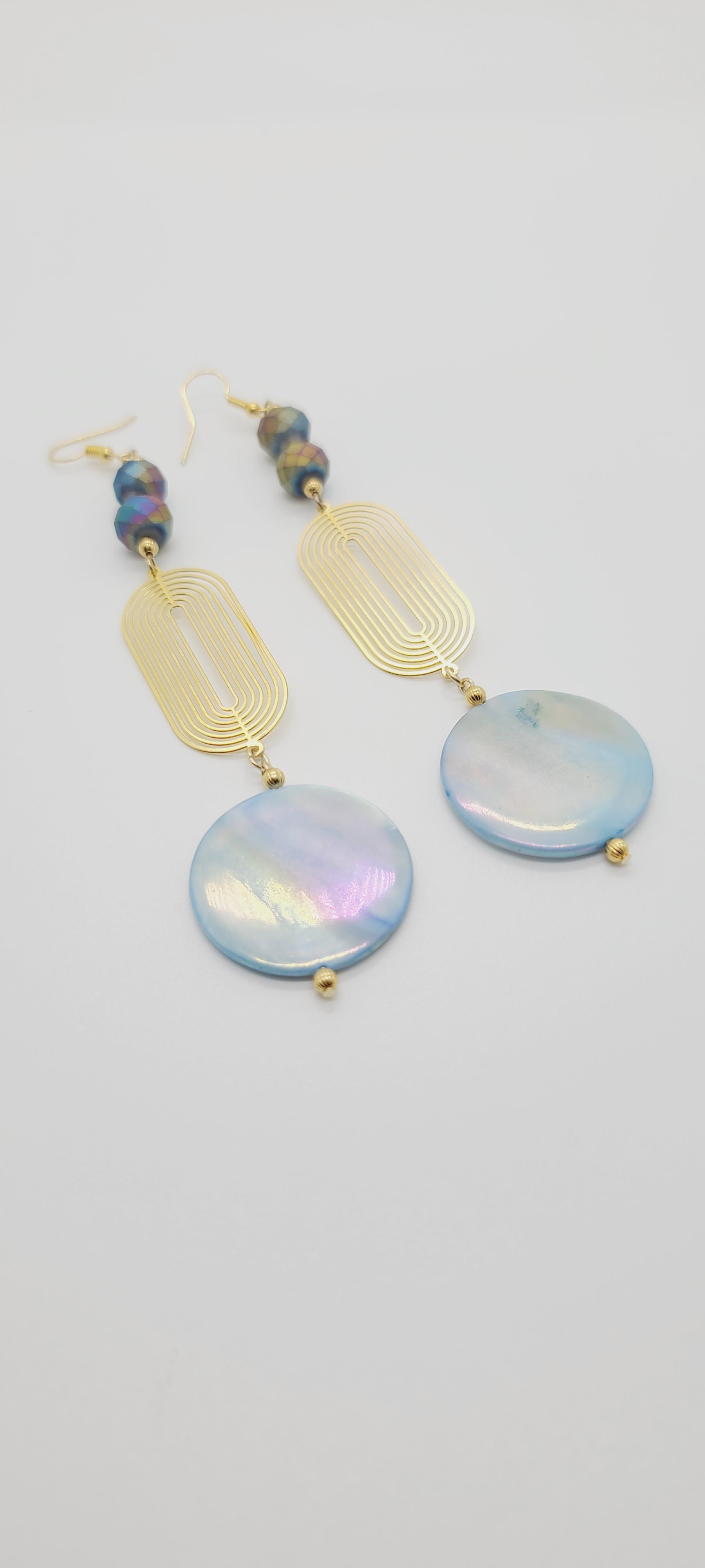 Length: 5 inches | Weight: 0.6 ounces  Distinctly You! These earrings are made with blue Abalone Shell discs, 10mm iridescent blue purple faceted glass stones, gold seed beads, and art deco oval gold charm.