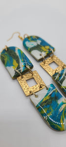 Length: 4.5 inches | Weight: 0.8 ounces  Distinctly You! These earrings are made with U-shape polymer clay in aqua yellow gold white green, and gold squared hammered charms.