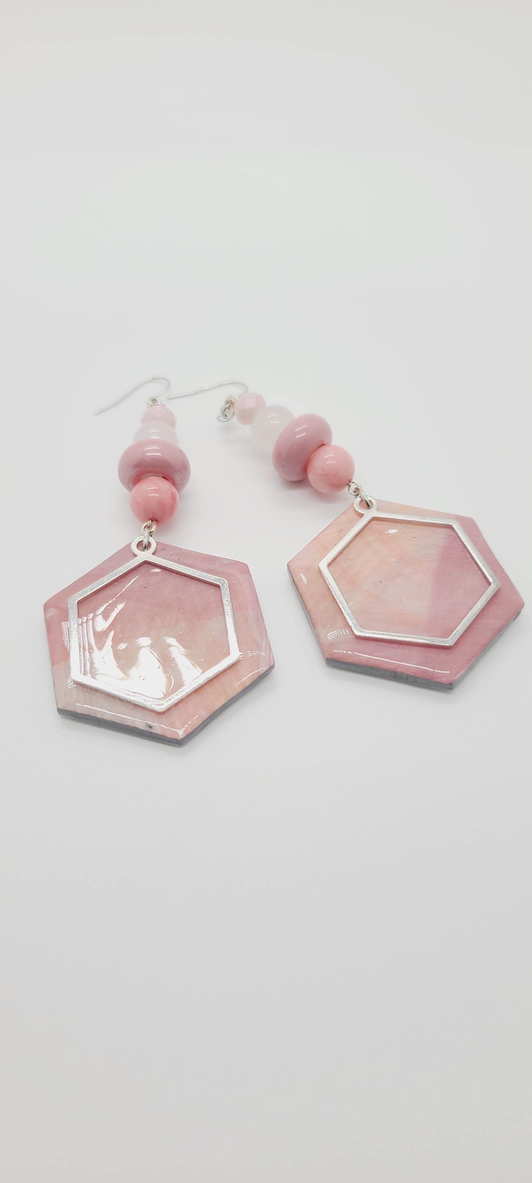 Length: 4 inches | Weight: 1.1 ounces  Distinctly You! These earrings are made with hexagon shapes and charms using polymer clay in pink and white, 10mm pink and frosted white glass beads, pink rondelles, and 6mm pink faceted glass stones.