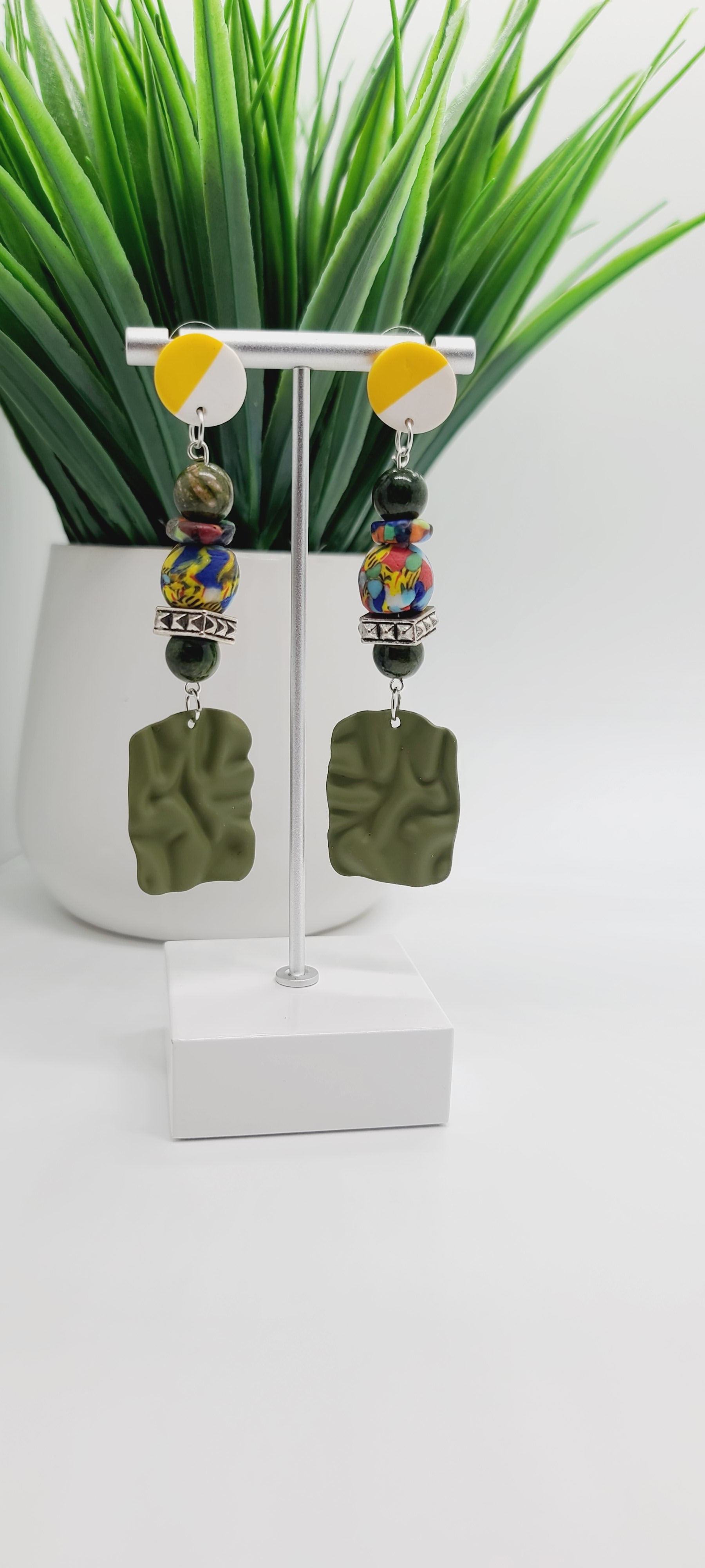 Length: 3.5 inches | Weight: 1.1 ounces  Distinctly You! These yellow and white ceramic post earrings are made with olive green rubbered metal charms, 10mm olive green Agate atones, 14mm house medley Ghana glass beads and rondelles, and silver squared rondelles.