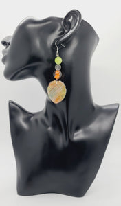 Length: 3.5 inches | Weight: 0.7 ounces  Distinctly You! These earrings are made with teardrop-shaped polymer clay in orange green gold with gold flakes, 12mm clear and orange glass beads, 10mm matte green ceramic beads, and silver tree charm.