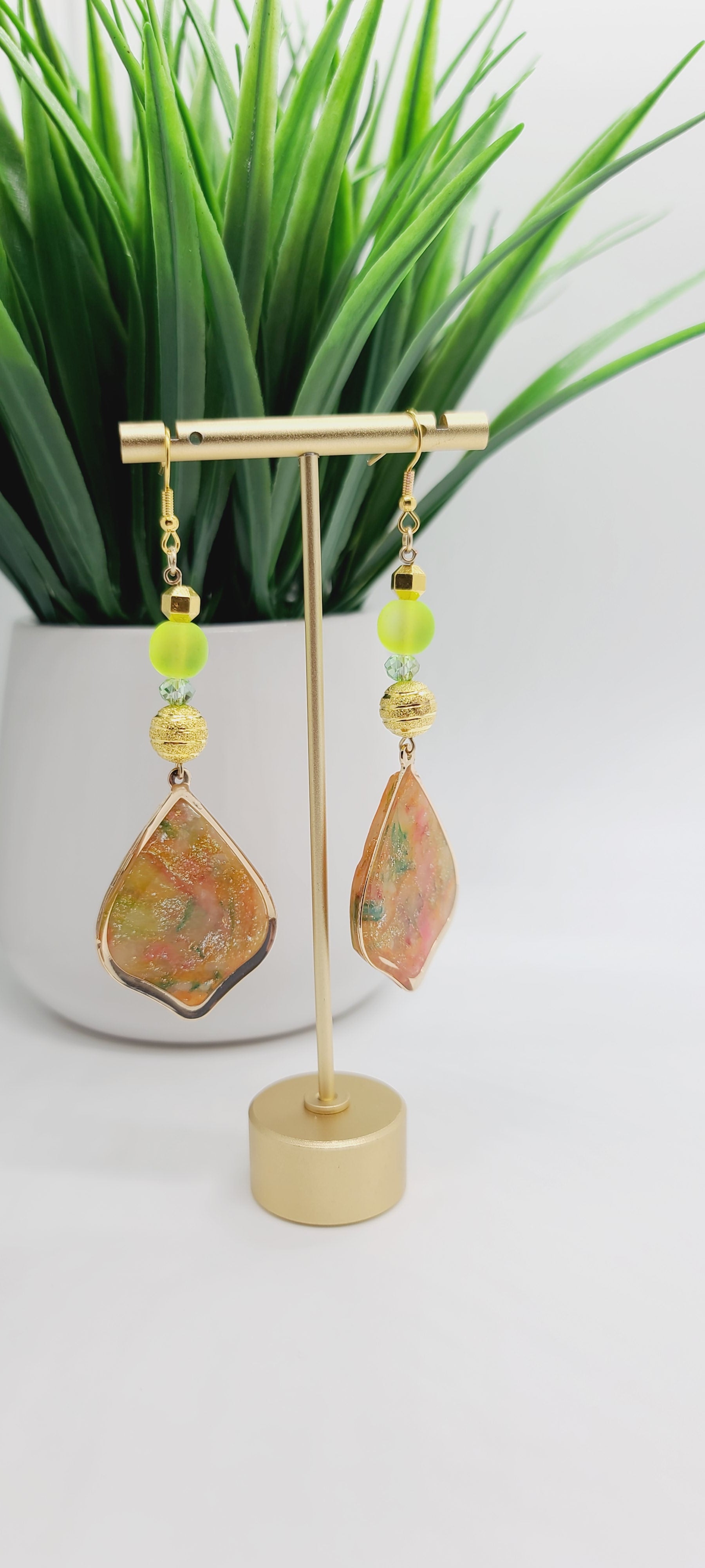 Length: 3.75 inches | Weight: 0.7 ounces  Distinctly You! These earrings are made with gold teardrop frame with inlaid polymer clay in orange green gold with gold flakes,10mm gold sparkle striped metal beads, 10mm frosted lime green glass beads, 4mm iridescent faceted glass beads, and 6mm gold faceted beads.