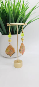 Length: 3.75 inches | Weight: 0.7 ounces  Distinctly You! These earrings are made with gold teardrop frame with inlaid polymer clay in orange green gold with gold flakes,10mm gold sparkle striped metal beads, 10mm frosted lime green glass beads, 4mm iridescent faceted glass beads, and 6mm gold faceted beads.