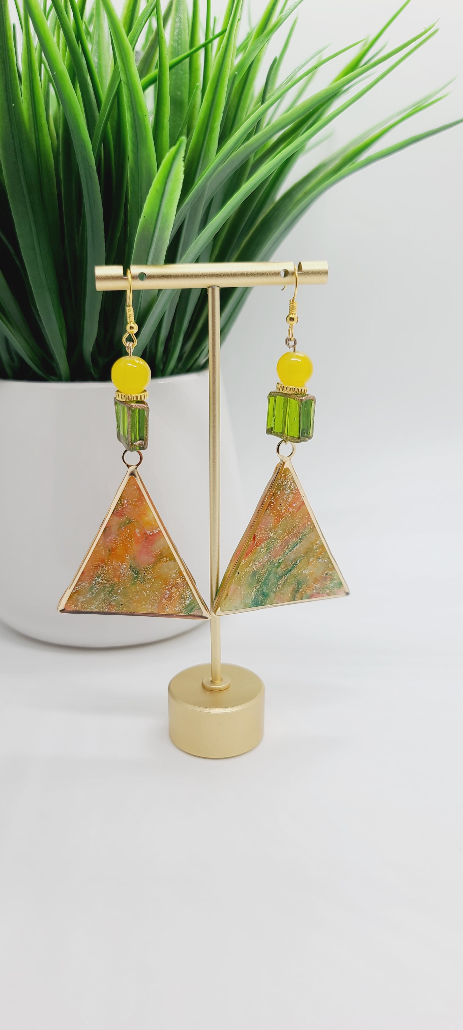 Length: 3.75 inches | Weight: 0.8 ounces  Distinctly You! These earrings are made with gold triangle frames with inlaid polymer clay in orange gold green with gold flakes, 10mm yellow glass beads, gold trim green glass box beads, and gold rondelles.