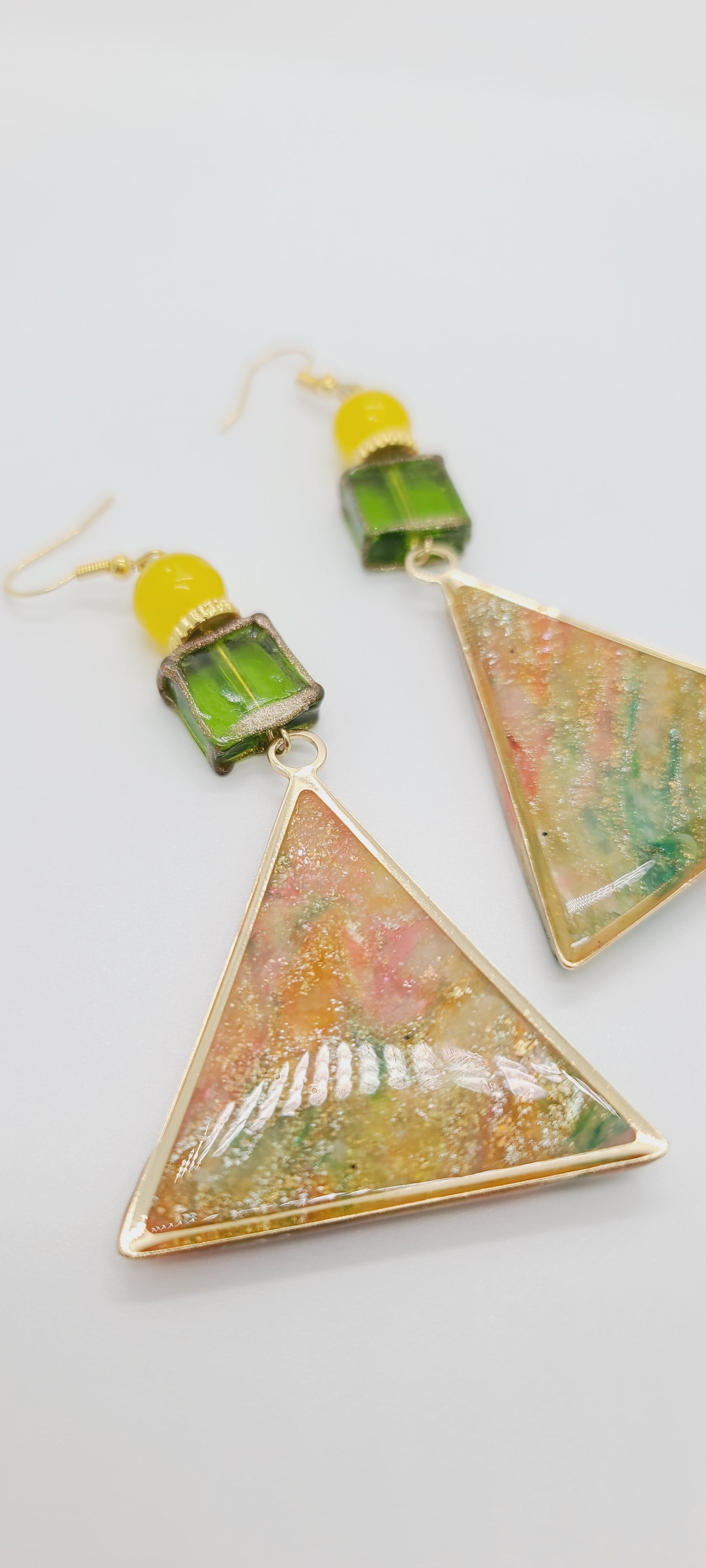 Length: 3.75 inches | Weight: 0.8 ounces  Distinctly You! These earrings are made with gold triangle frames with inlaid polymer clay in orange gold green with gold flakes, 10mm yellow glass beads, gold trim green glass box beads, and gold rondelles.