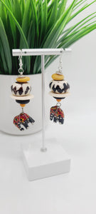 Length: 3 inches | Weight: 0.8 ounces  Distinctly You! These earrings are made with ethnic print red and black wooden hand painted elephants from artisans in Copenhagen Denmark, white Batik bone discs, black and gold Ashanti glass rondelles, black and white large Batik bone beads, and silver spacers.