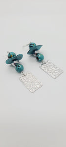 Length: 3 inches | Weight: 0.7 ounces  Distinctly You! These earrings are made with large turquoise Ashanti glass saucers, silver hammered square charms, 10mm turquoise and black ceramic beads, and silver black iridescent faceted glass beads.