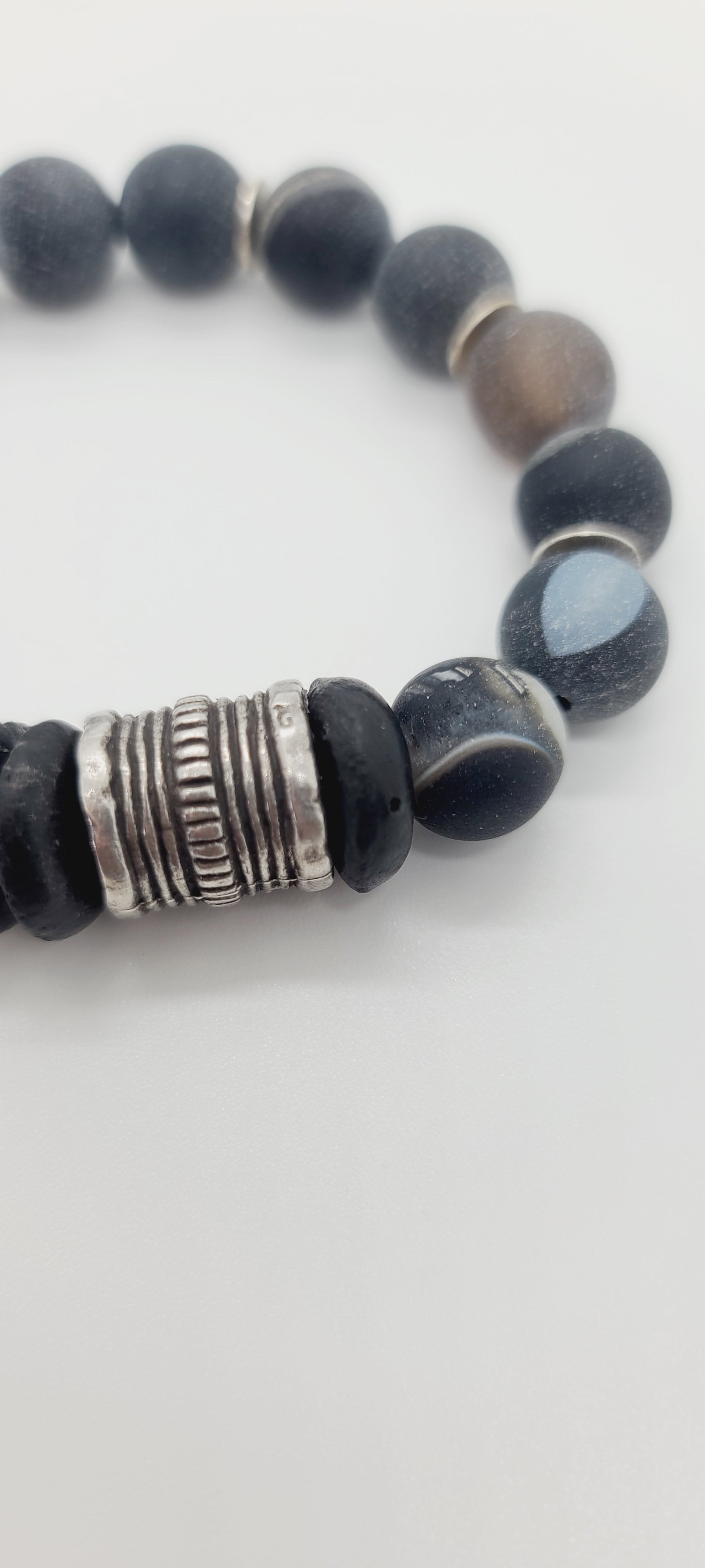 Length: 7.75 inches | Weight: 1.8 ounces  Distinctly You! This bracelet is made with 12mm dark grey spiral Agate beads, 14mm Ashanti glass rondelles, with accents of silver spacers and chrome charms.