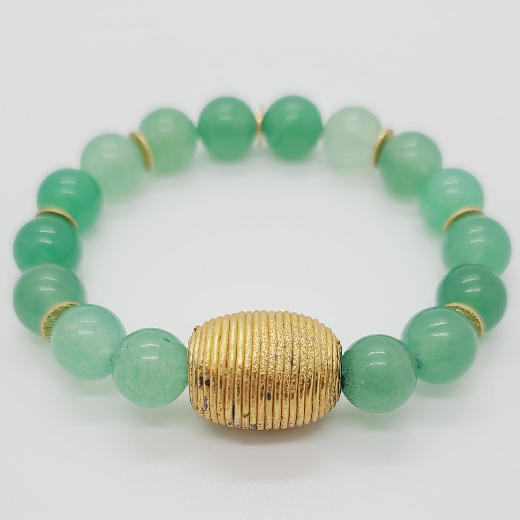 Length: 7.75 inches | Weight: 1.9 ounces  Distinctly You! This bracelet is made with 12mm seafoam green glass beads, with accents of gold spacers and Cameroon gold charm