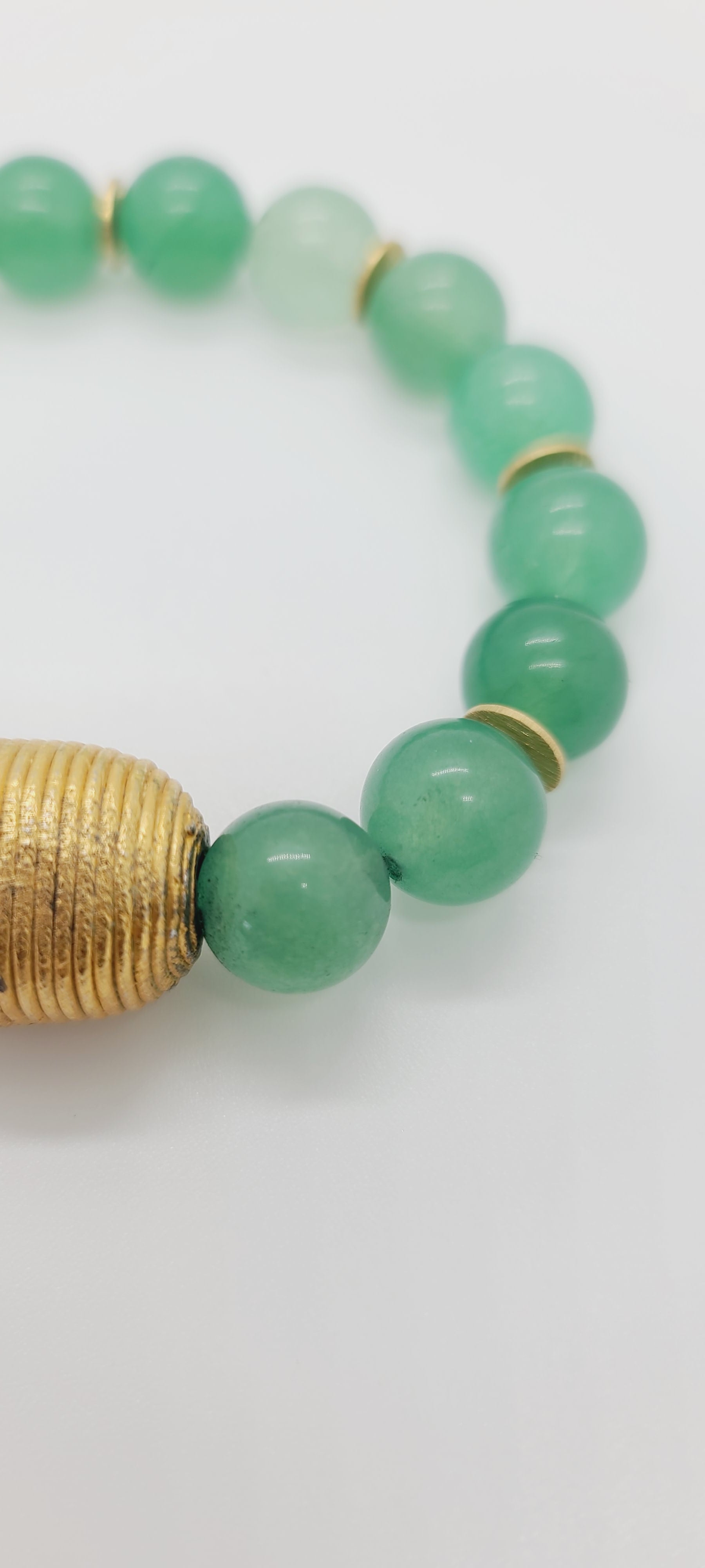 Length: 7.75 inches | Weight: 1.9 ounces  Distinctly You! This bracelet is made with 12mm seafoam green glass beads, with accents of gold spacers and Cameroon gold charm