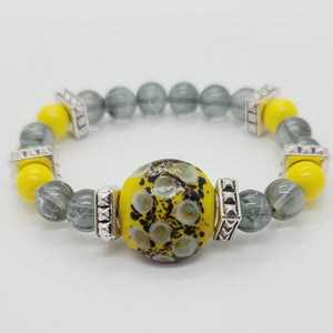 Length: 7.75 inches | Weight: 1.8 ounces  Distinctly You! This bracelet is made with 10mm yellow ceramic and grey white painted glass beads, accented with chrome square spacers, grey and yellow speckle ceramic center charm.