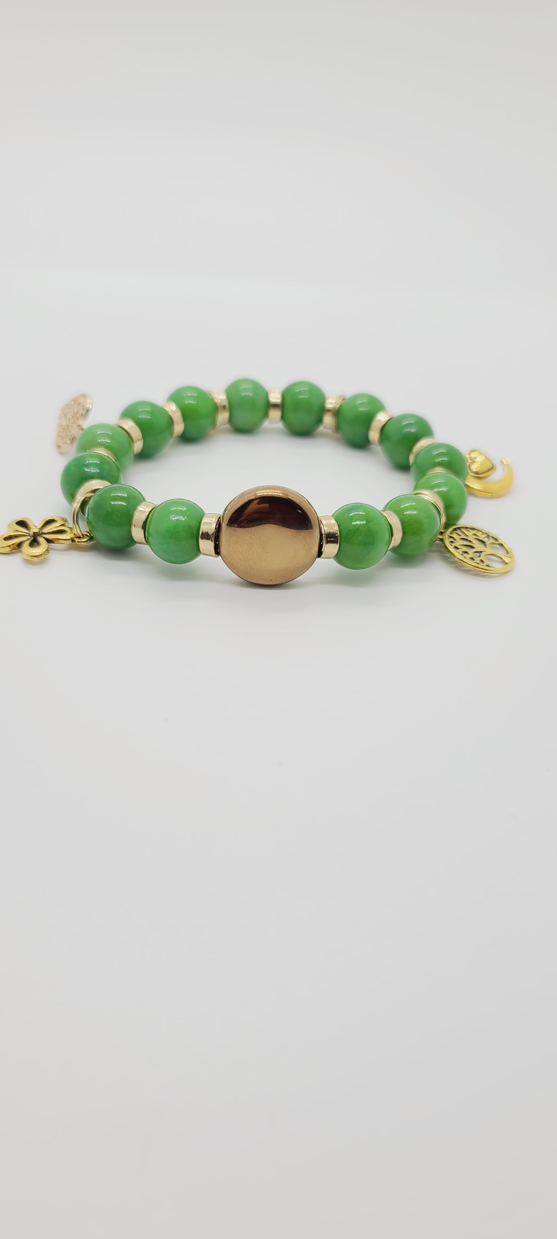 Length: 7.75 inches | Weight: 2 ounces  Distinctly You! This bracelet is made with 12mm rich green ceramic Beads, 16mm gold glass disc centerpiece, with gold charms and spacers.