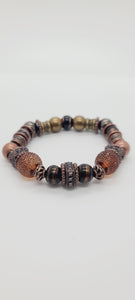Length: 7.75 inches | Weight: 2.6 ounces  Distinctly You! This double stack bracelet is made with 10mm black and copper glass beads, 10mm copper metal beads,10mm Hematite beads, 12mm resin sparkle beads, copper diamond shaped centerpiece, 10mm copper and brass charms and spacers.
