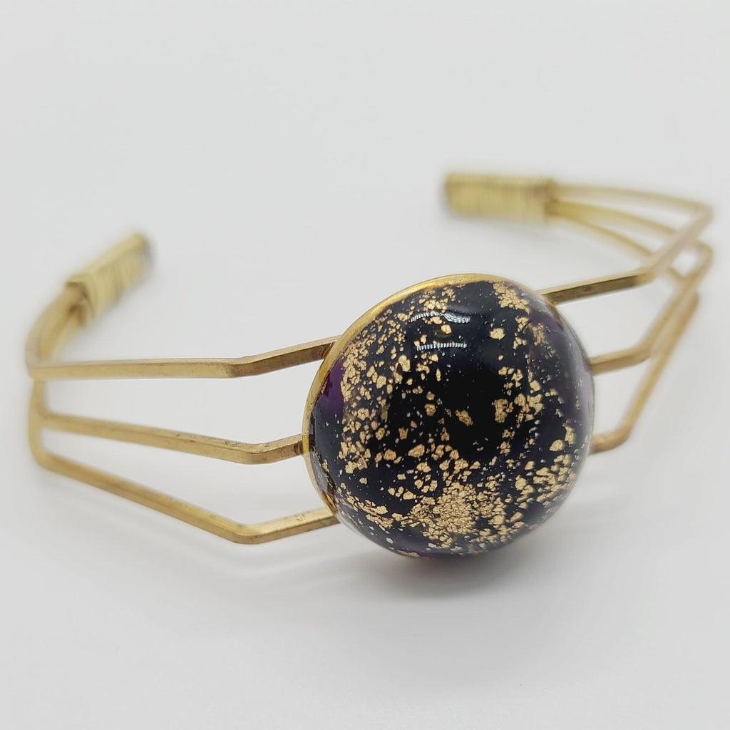 Length: 6.75 inches | Weight: 0.6 ounces  Distinctly You! This brass metal bracelet is made with black and gold polymer clay stone covered in resin.