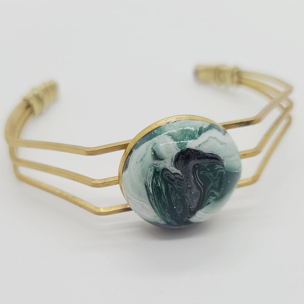Length: 6.75 inches | Weight: 0.6 ounces  Distinctly You! This brass metal bracelet is made with multi-colored green, white, black swirl polymer clay covered in resin.