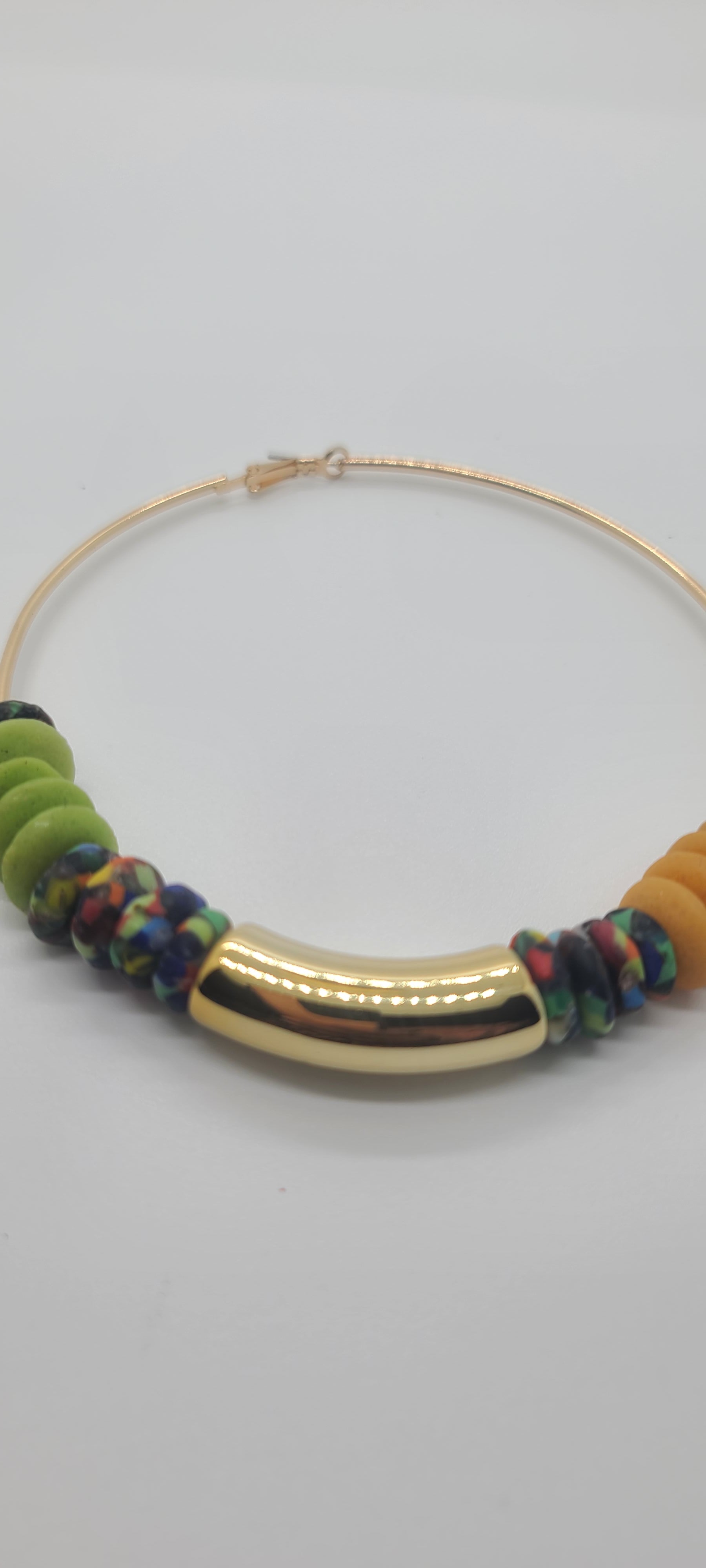Length: 4x4 inches | Weight: 1.9 ounces  Distinctly You! These earrings are made with large gold Hoops, gold, green, multi-colored print Ashanti glass saucers, and curved gold resin charm.