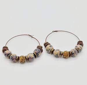 Length: 4x4 inches | Weight: 2.7 ounces  Distinctly You! These earrings are made with large brown hoops, 15mm and 12mm assorted wooden and sequin beads, 10mm resin gold rondelles, and brown mesh rondelles.