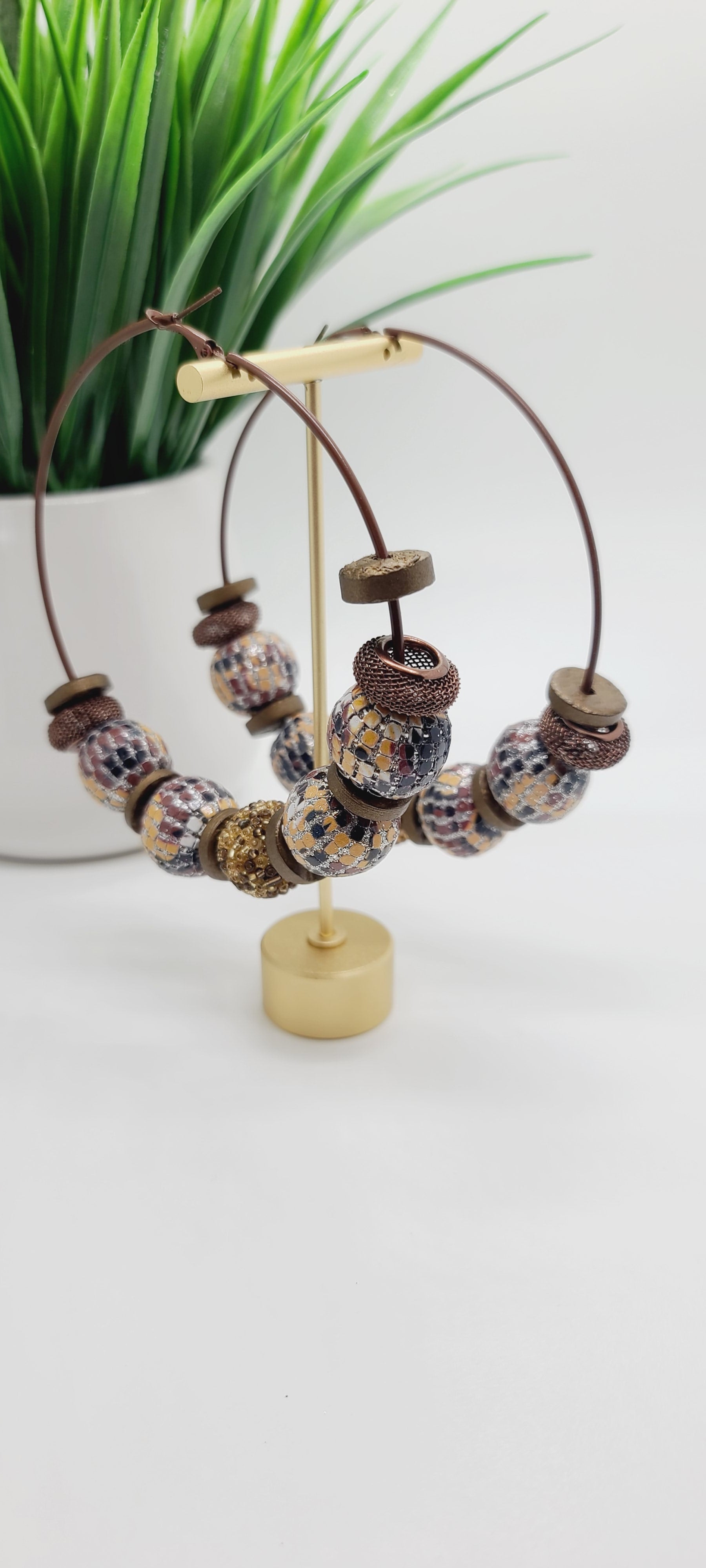 Length: 4x4 inches | Weight: 2.7 ounces  Distinctly You! These earrings are made with large brown hoops, 15mm and 12mm assorted wooden and sequin beads, 10mm resin gold rondelles, and brown mesh rondelles.