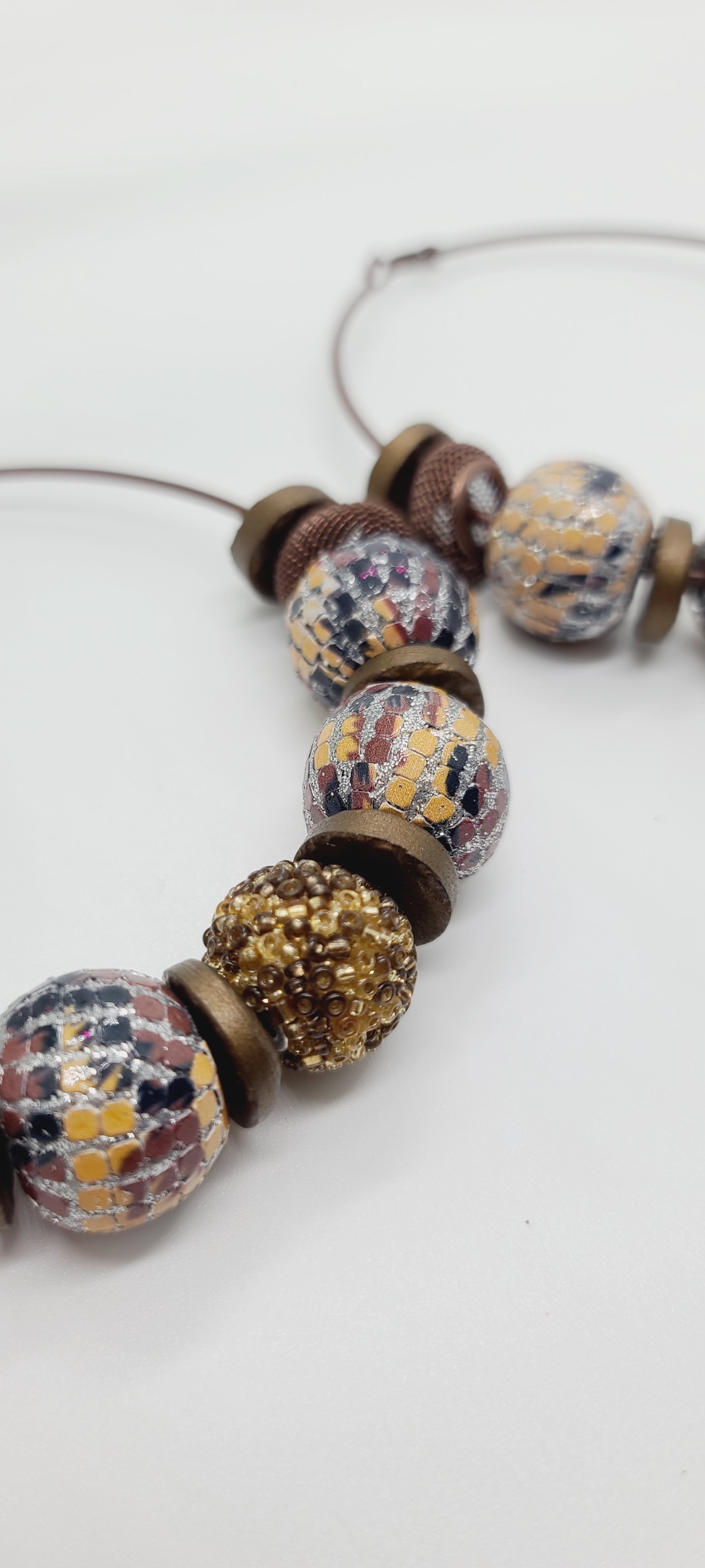 Length: 4x4 inches | Weight: 2.7 ounces  Distinctly You! These earrings are made with large brown hoops, 15mm and 12mm assorted wooden and sequin beads, 10mm resin gold rondelles, and brown mesh rondelles.