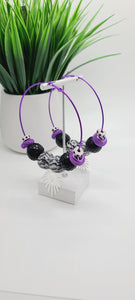 Length: 3.5x3.5 inches | Weight: 2.2 ounces  Distinctly You! These earrings are made with large purple hoops,15mm black and white striped beads, black and silver sequin beads, purple mesh rondelles, chrome hexagon rondelles, and silver sunburst charm.