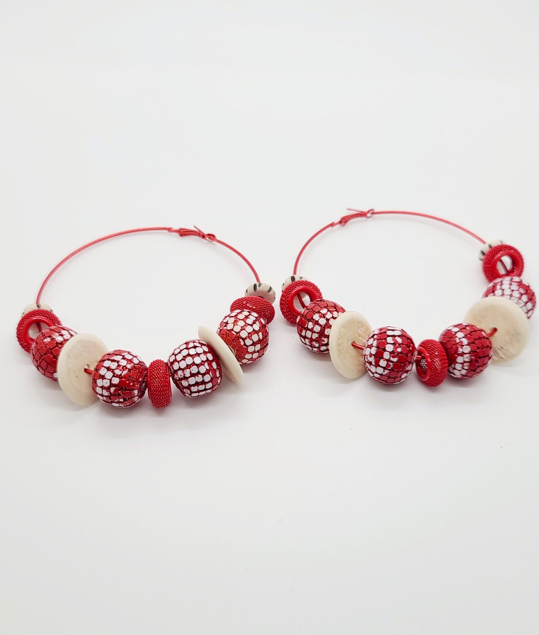 Length: 3.5x3.5 inches | Weight: 2.4 ounces  Distinctly You! These earrings are made with large red hoops,15mm red sequin beads, 15mm Batik bone disc, red mesh rondelles, and 10mm black and white Batik bone rondelles.