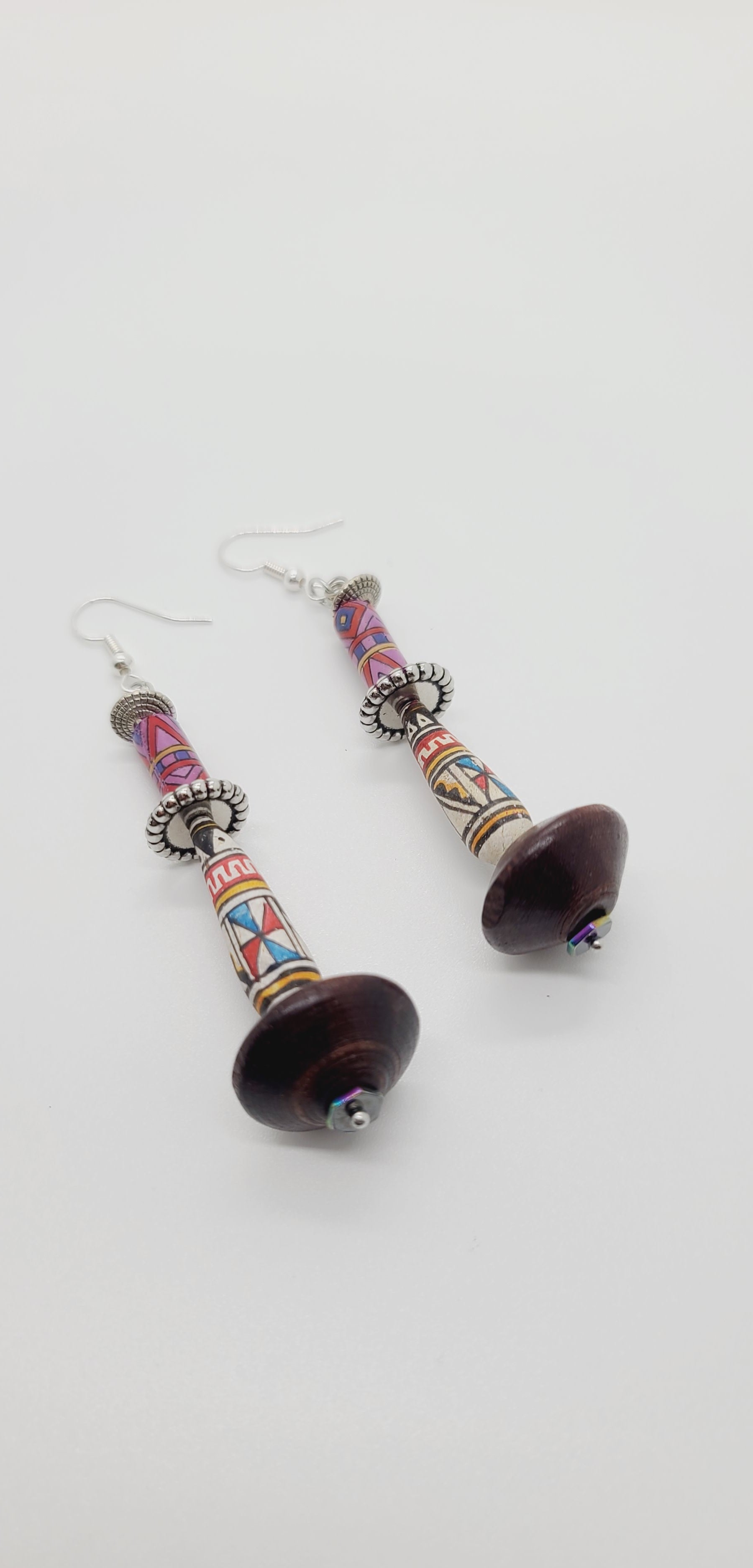 Length: 3 inches | Weight: 0.5 ounces  Distinctly You! These earrings are made with brown wooden Bicone beads, ethnic print beads, accented with silver rondelles.