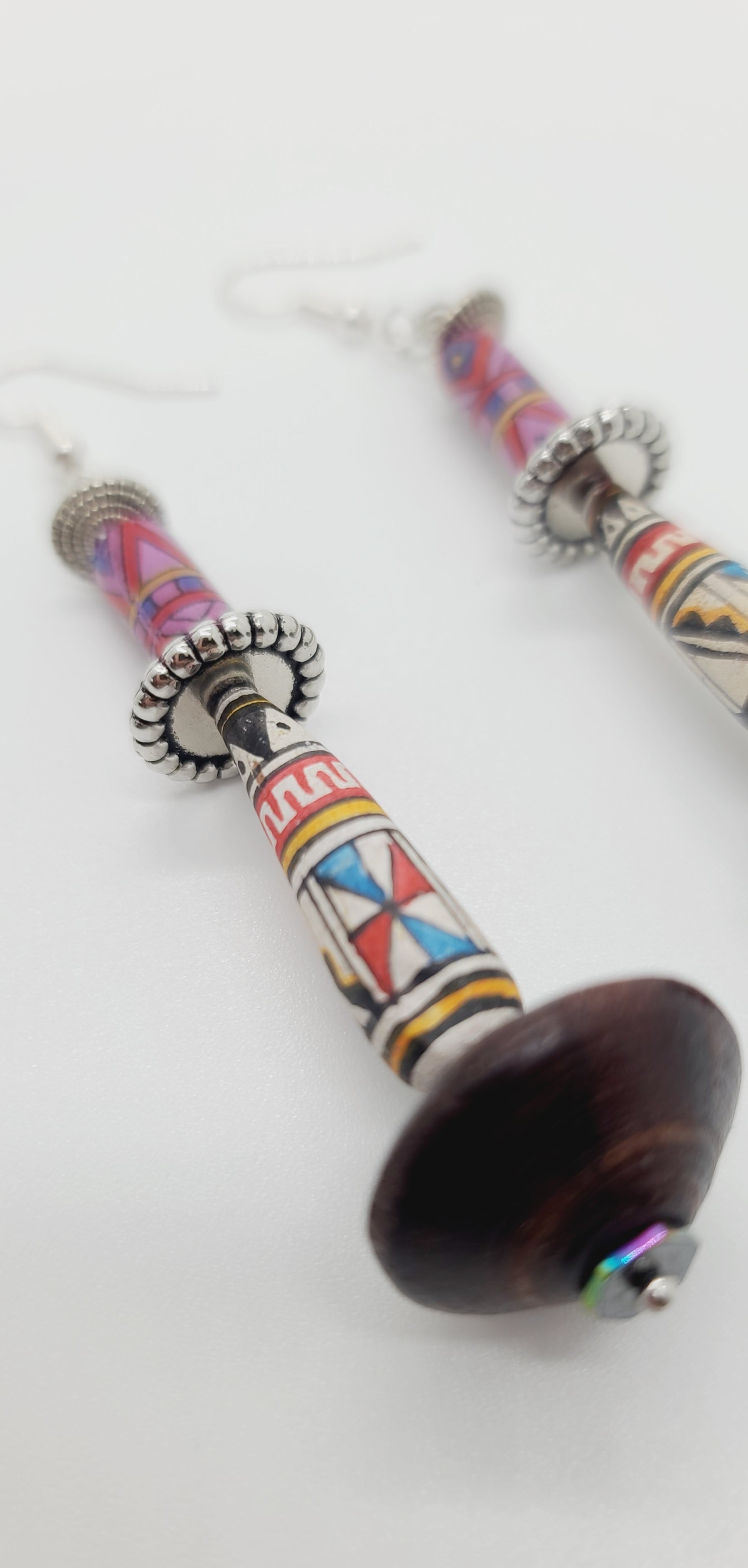 Length: 3 inches | Weight: 0.5 ounces  Distinctly You! These earrings are made with brown wooden Bicone beads, ethnic print beads, accented with silver rondelles.