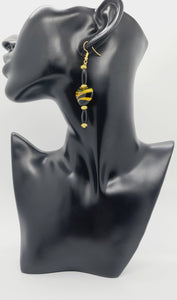 Length: 3 inches | Weight: 0.6 ounces  Distinctly You! These earrings are made with black and gold swirl glass heart shape stones, black hair bone, accented with gold rondelles.