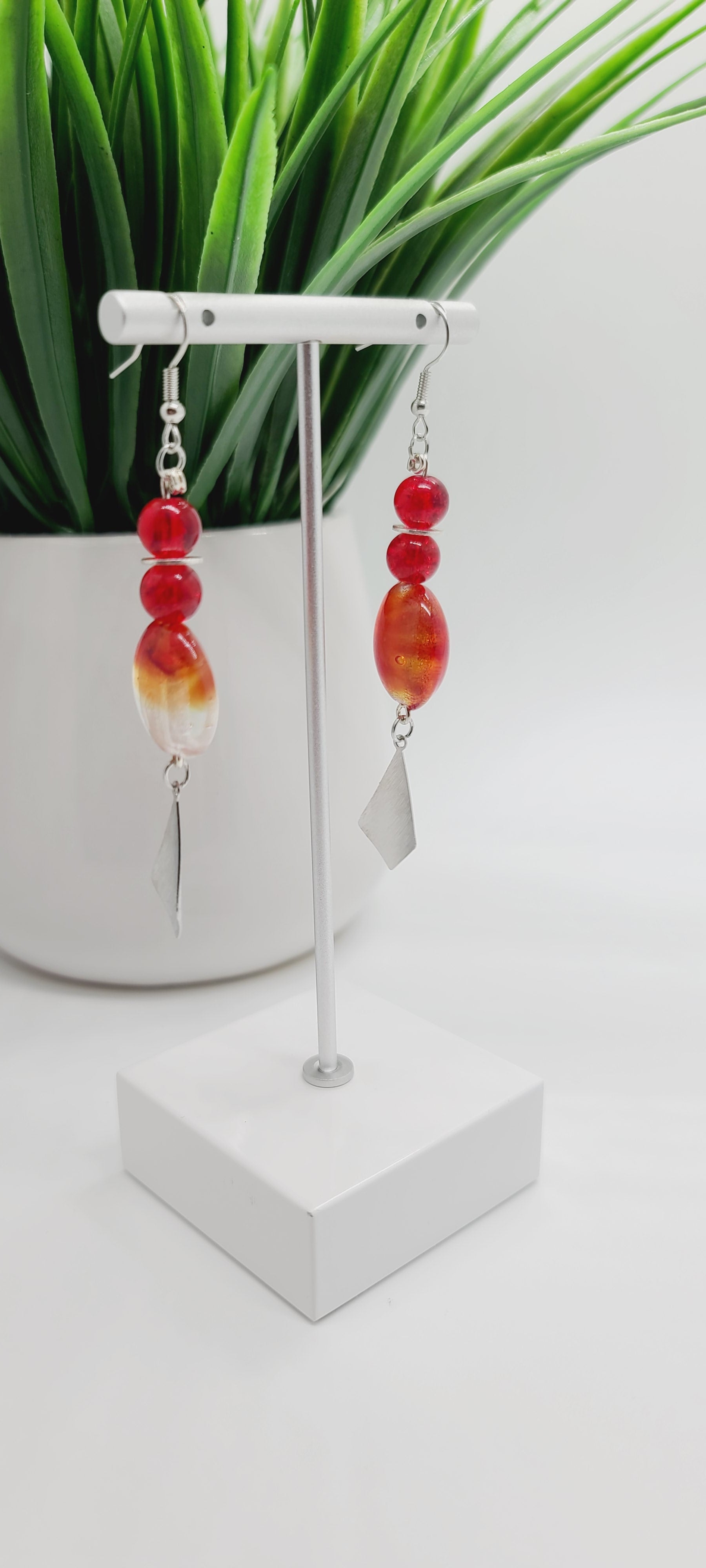 Length: 3 inches | Weight: 0.6 ounces  Distinctly You! These earrings are made with red and silver swirl Italian Murano glass stones, 8mm red glass beads, accented with silver rondelles and charms.