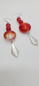 Length: 3 inches | Weight: 0.6 ounces  Distinctly You! These earrings are made with red and silver swirl Italian Murano glass stones, 8mm red glass beads, accented with silver rondelles and charms.