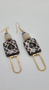 Length: 2.75 inches | Weight: 0.6 ounces  Distinctly You! These earrings are made with black and white checkered pattern square Batik bone beads, 12mm Ivory lava stone, blue and gold Czech glass beads, and gold charms.