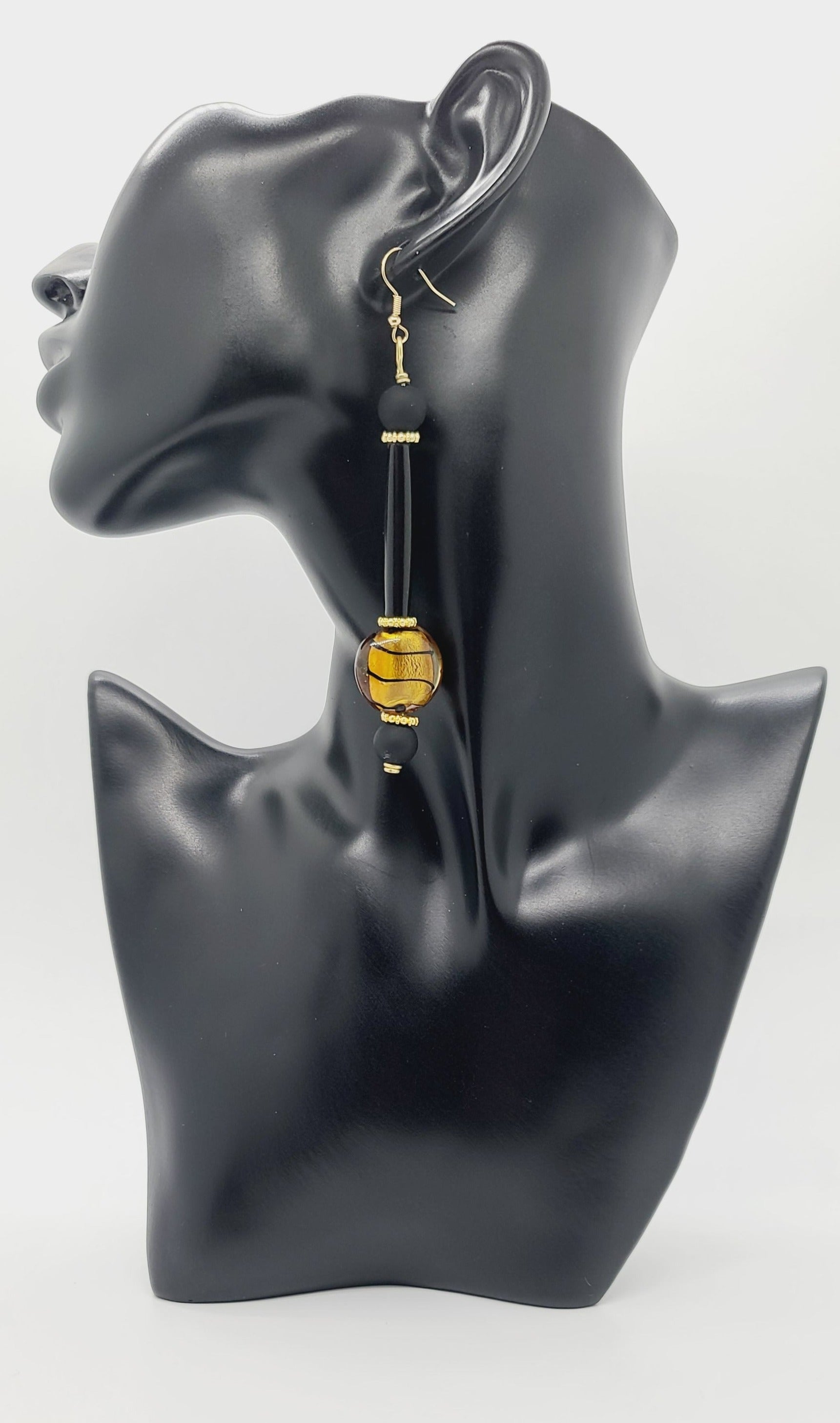 Length: 4.5 inches | Weight: 0.8 ounces  Distinctly You! These earrings are made with gold and black Italian Murano glass stones,10mm matte black glass beads, black hair bone tube, and gold rondelles.