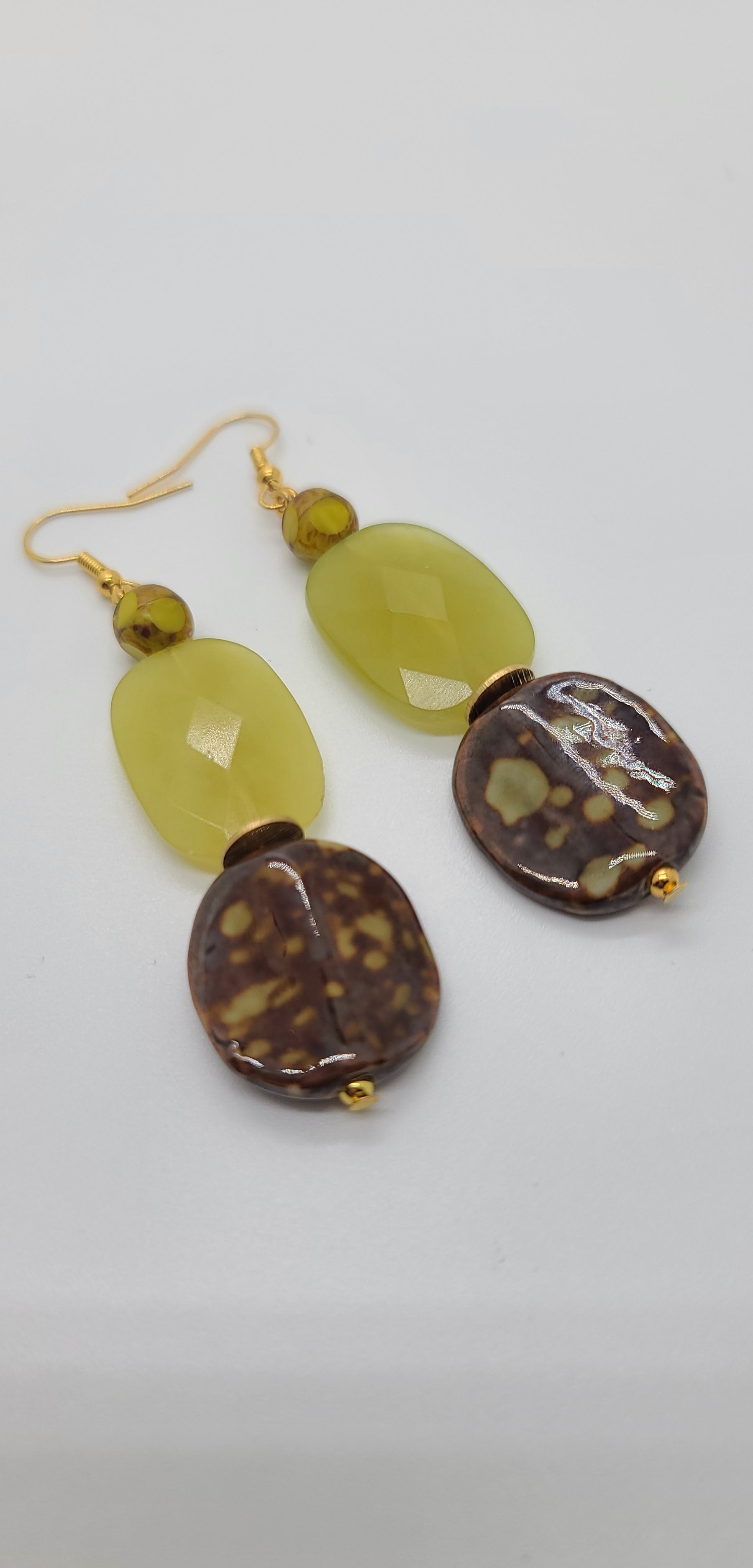 Length: 3 inches | Weight: 0.7 ounces  Distinctly You! These earrings are made with brown and gold print ceramic stones, citron green glass faceted stones, 8mm brown and green matte colored faceted glass beads, gold seed beads, and gold rondelles.