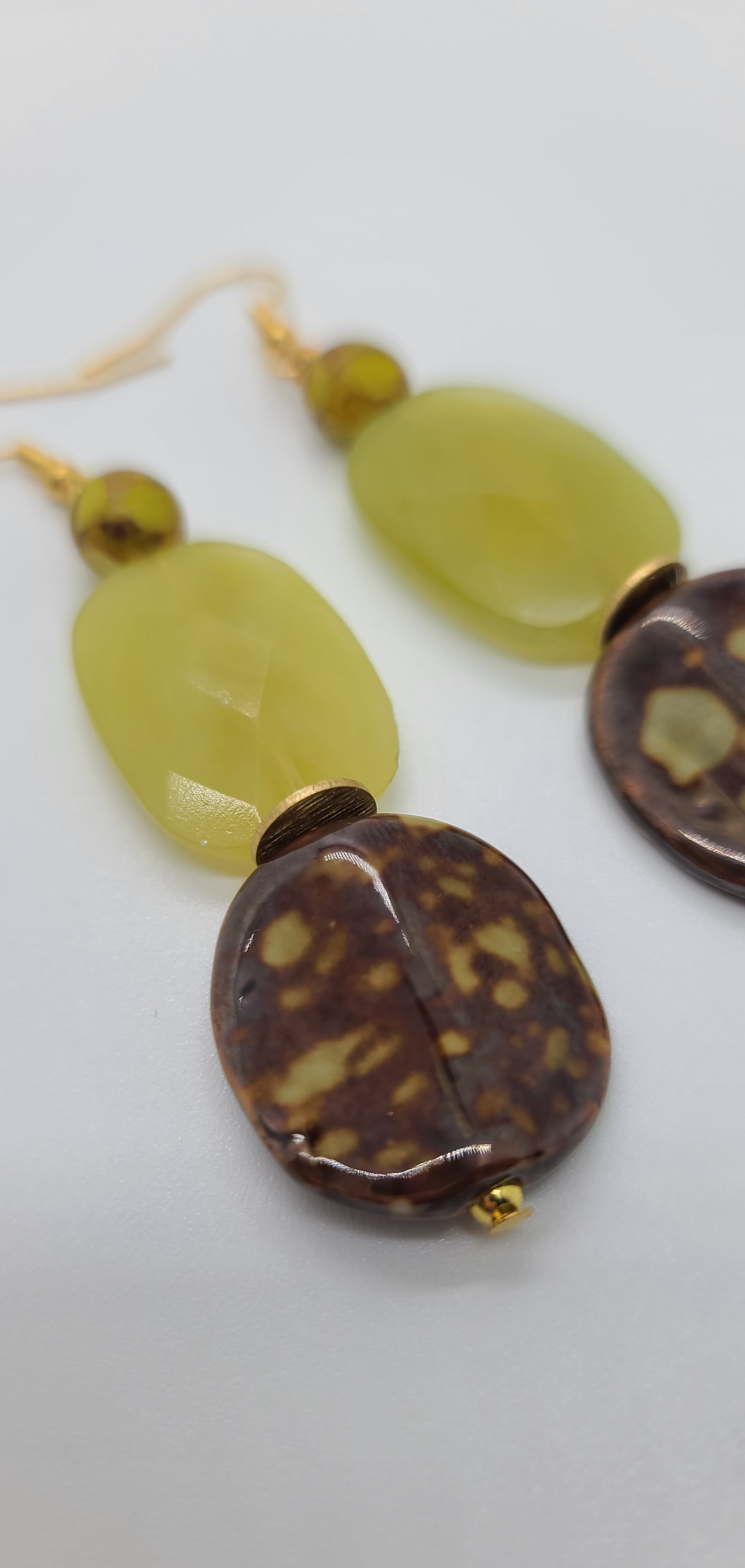 Length: 3 inches | Weight: 0.7 ounces  Distinctly You! These earrings are made with brown and gold print ceramic stones, citron green glass faceted stones, 8mm brown and green matte colored faceted glass beads, gold seed beads, and gold rondelles.