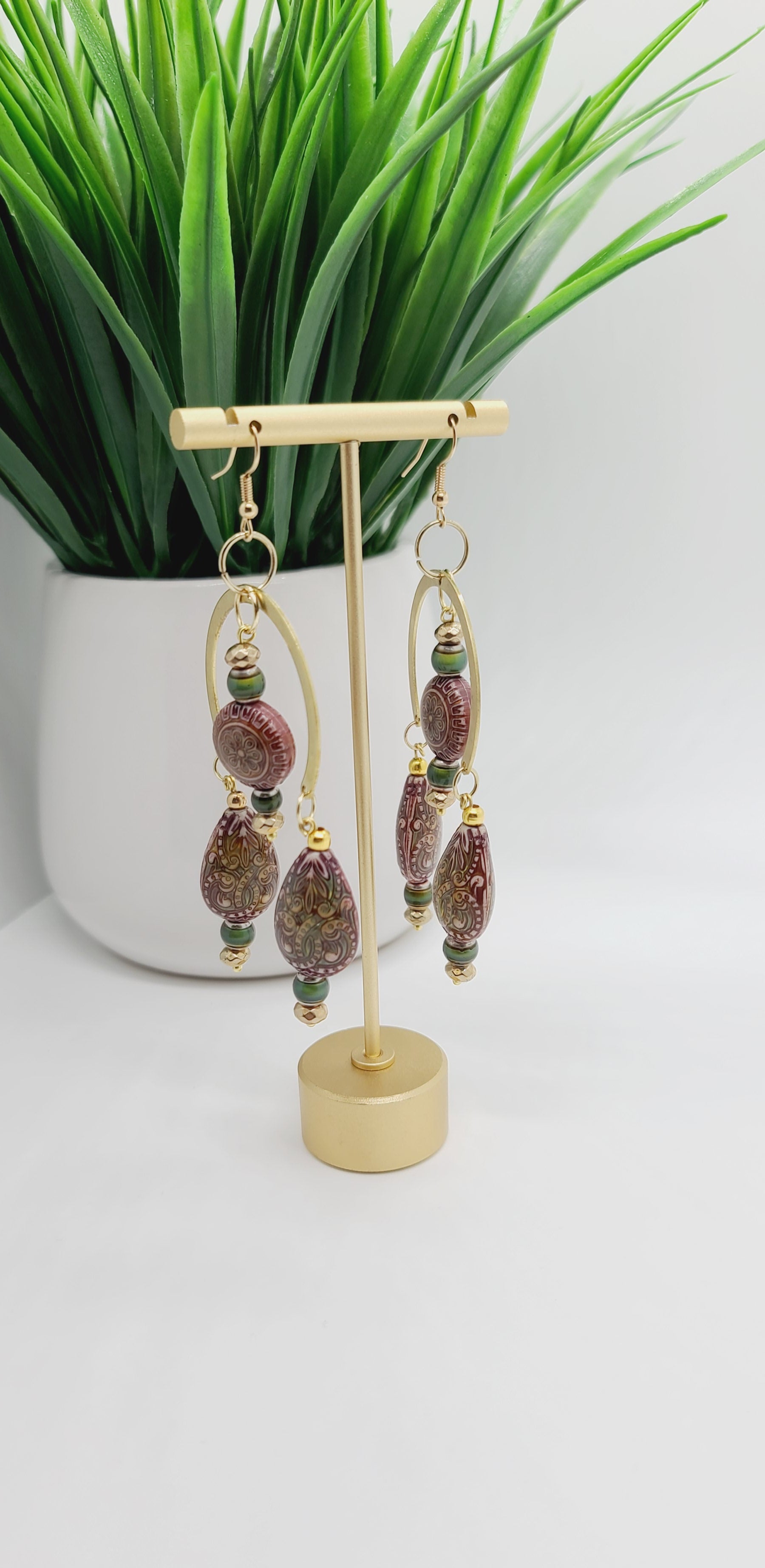 Length: 3.75 inches | Weight: 0.7 ounces  Distinctly You! These earrings are made with gold crescent moon charms, paisley printed wooden covered with resin beads, 6mm olive green resin beads, gold faceted spacers, and gold seed beads.