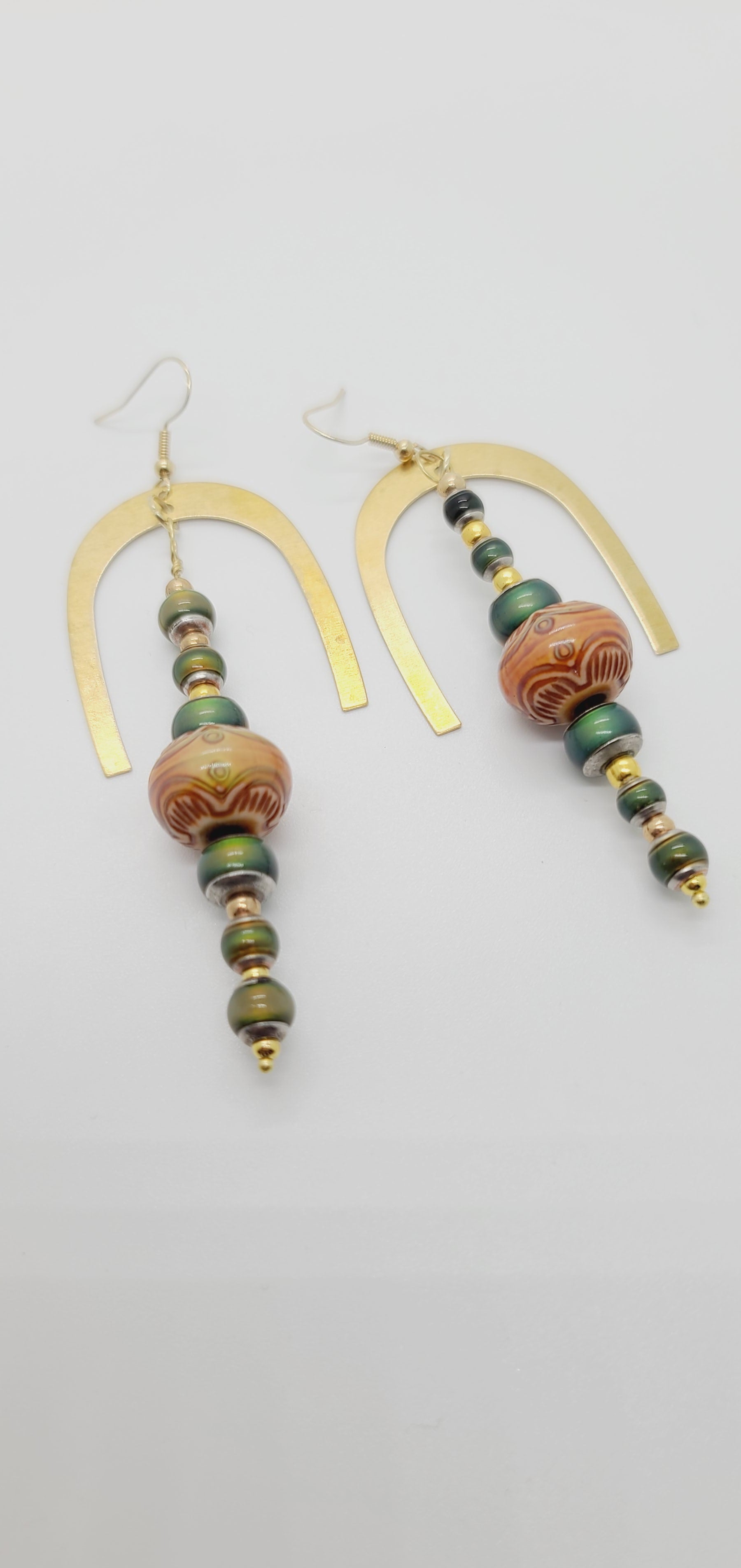 Length: 4 inches | Weight: 0.8 ounces  Distinctly You! These earrings are made with gold horseshoe charm, amber printed wood covered with resin beads, 6mm and 4mm green resin beads, and gold seed beads.