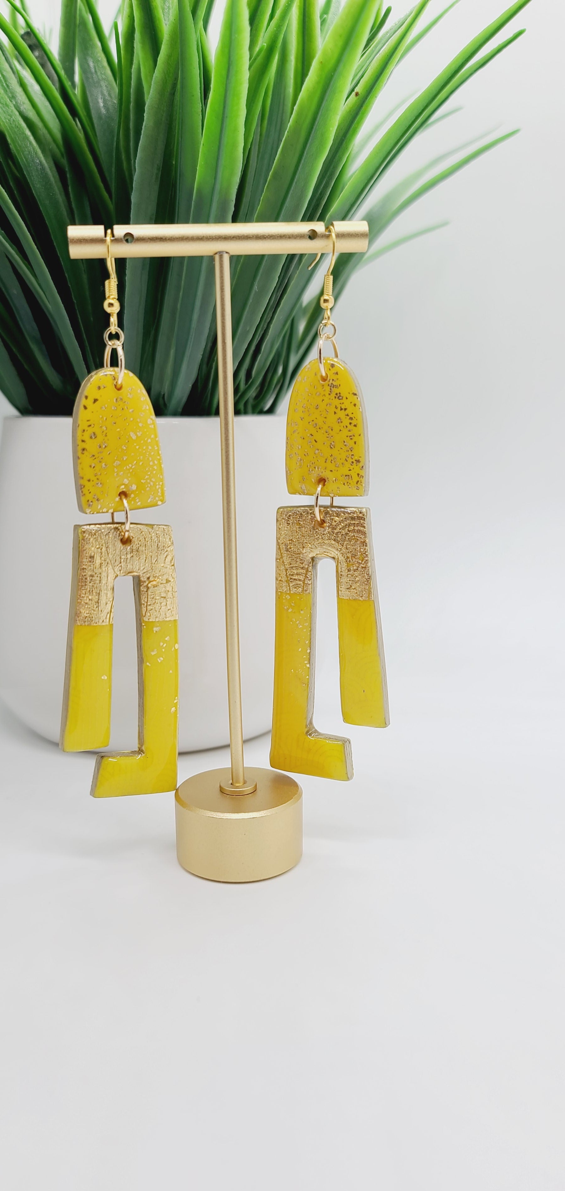 Length: 4.5 inches | Weight: 0.8 ounces  Distinctly You! These earrings are made with gold and canary yellow polymer clay covered in resin.