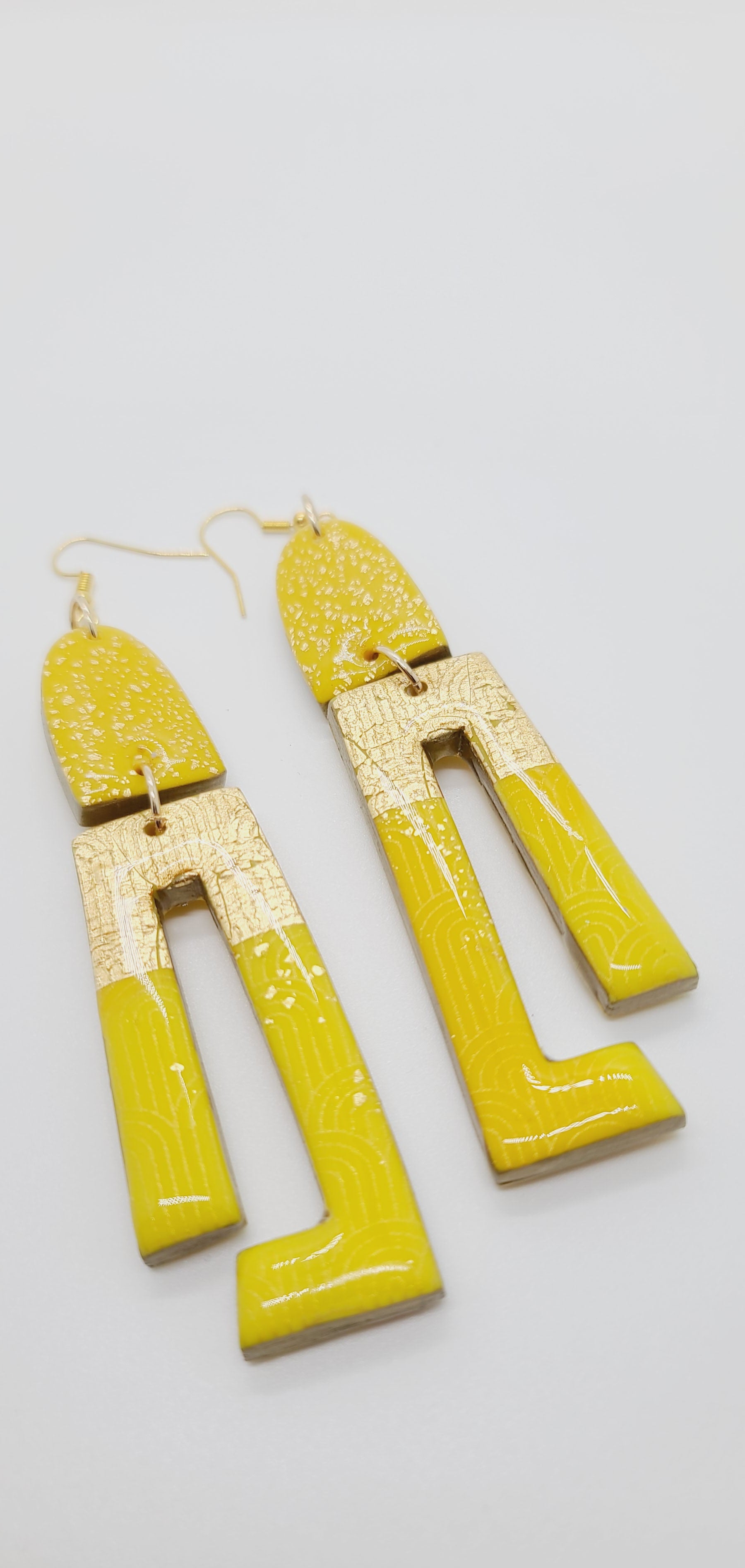 Length: 4.5 inches | Weight: 0.8 ounces  Distinctly You! These earrings are made with gold and canary yellow polymer clay covered in resin.