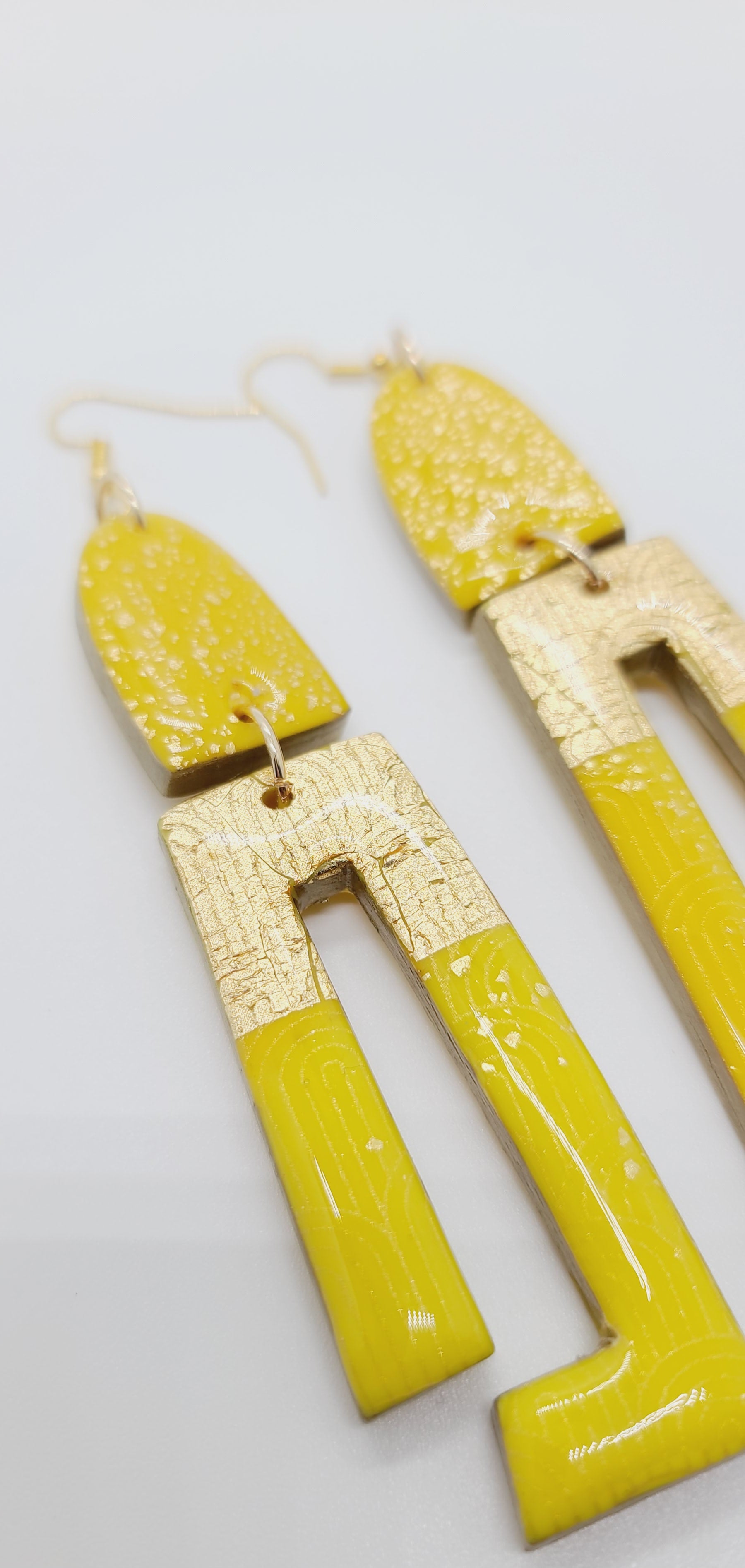 Length: 4.5 inches | Weight: 0.8 ounces  Distinctly You! These earrings are made with gold and canary yellow polymer clay covered in resin.