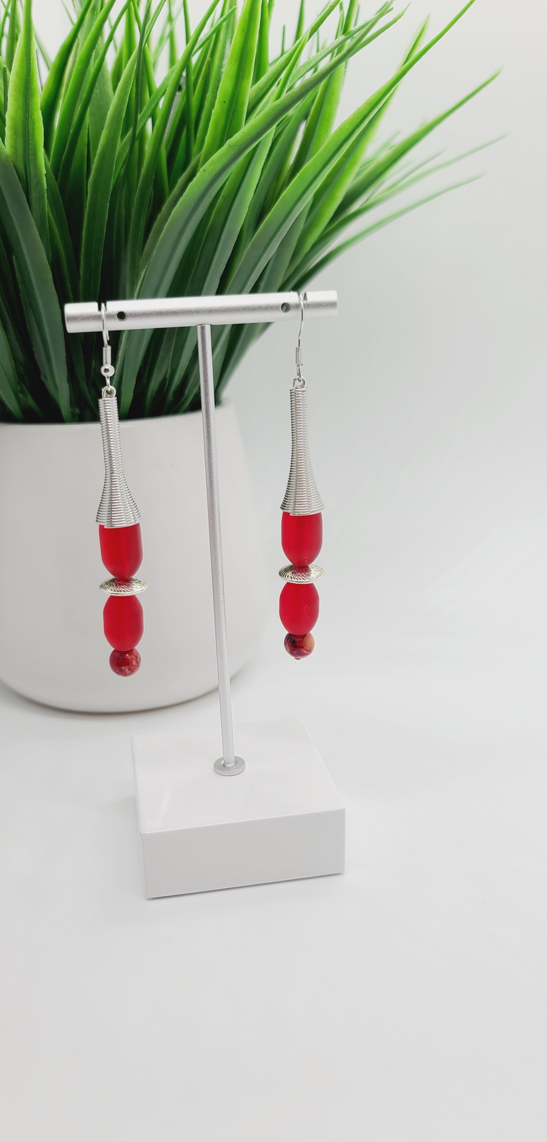 Length: 3.5 inches | Weight: 0.6 ounces  Distinctly You! These earrings are made with silver spring charms, silver rondelles, 12mm and 10mm oblong frosted red glass beads, and 6mm red marble glass beads.