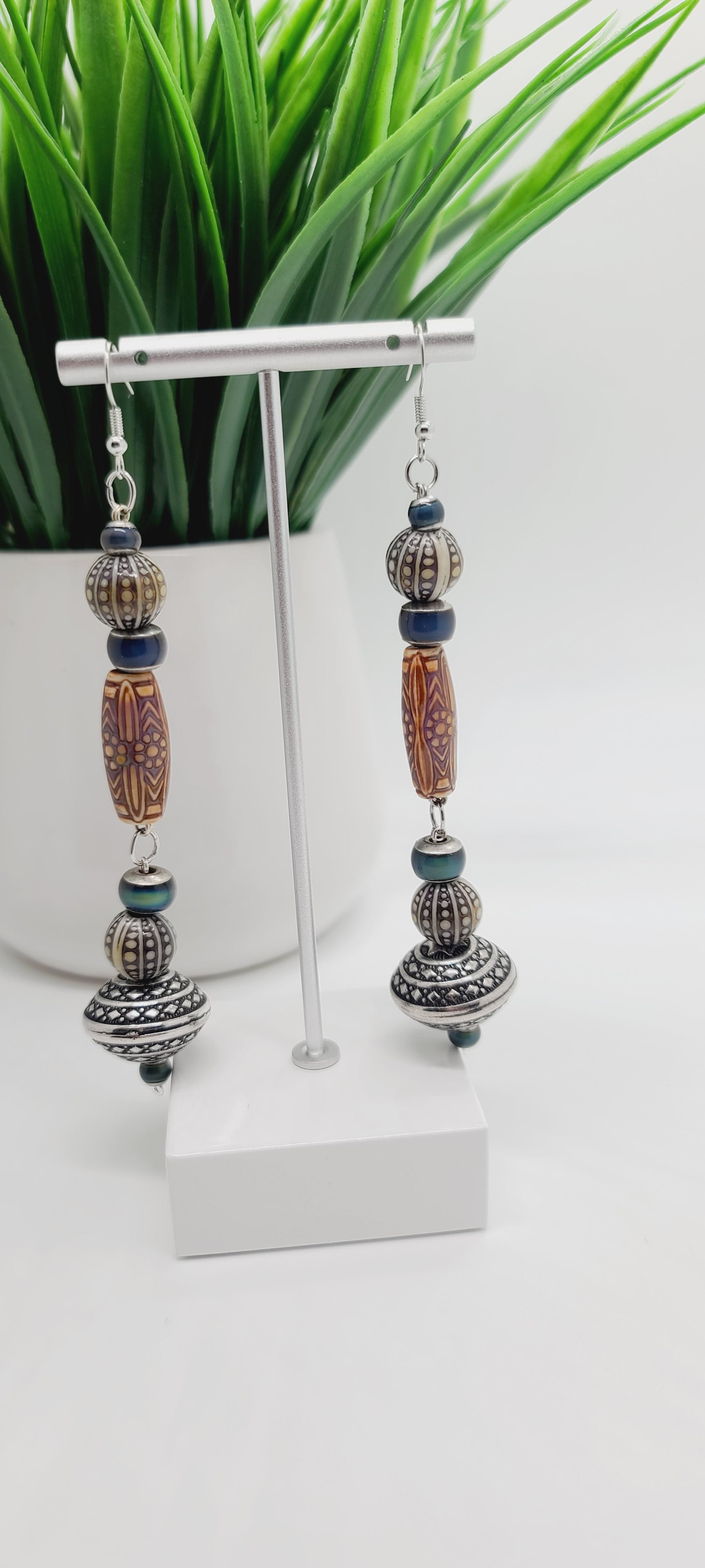 Length: 5 inches | Weight: 0.8 ounces  Distinctly You! These earrings are made with engraved silver Bicone charms, amber printed wood resin covered beads, 10mm grey and ivory printed resin beads, 3mm and 6mm green resin beads.