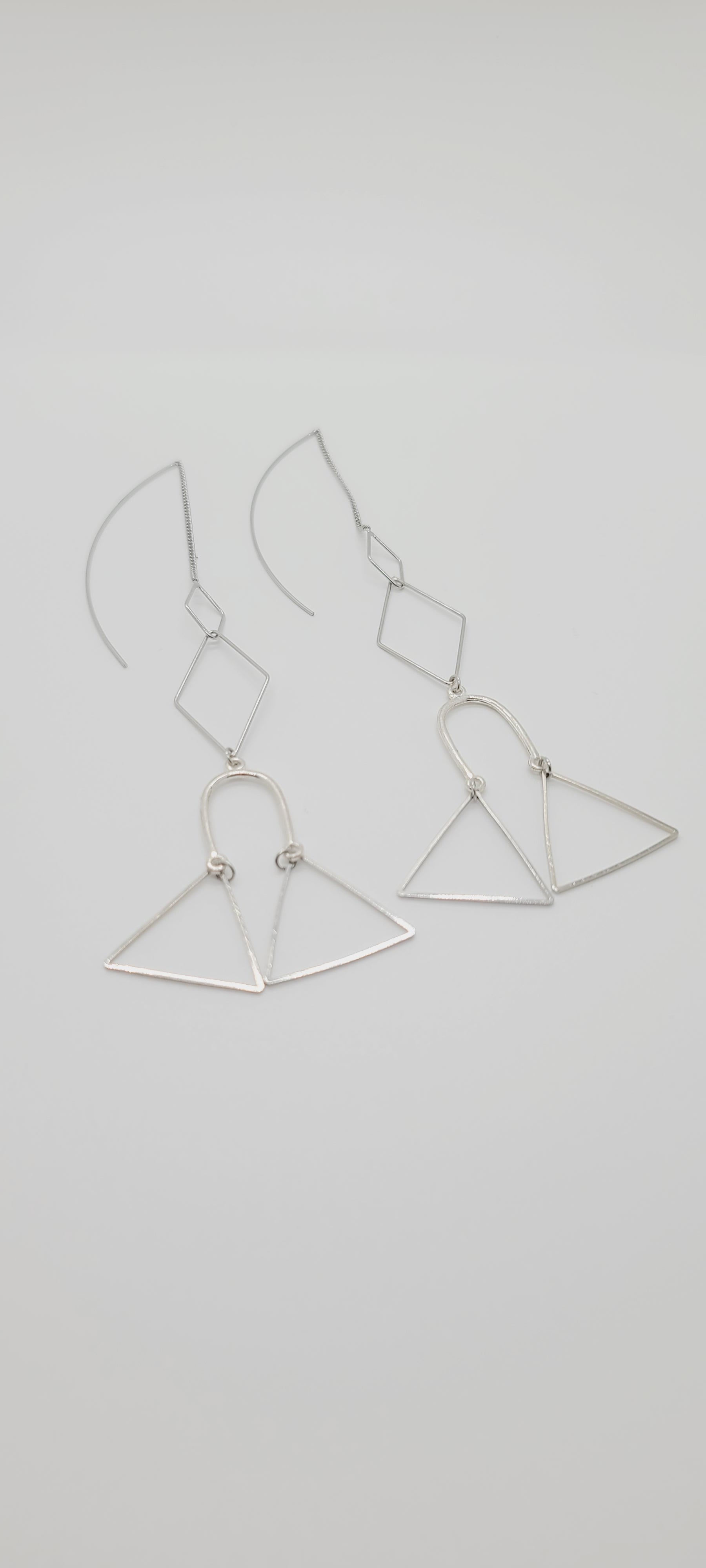 Length: 6 inches | Weight: 0.2 ounces  Distinctly You! These silver wire hook earrings are made with silver chains, silver charms in shapes of diamonds, triangles, and horseshoes.