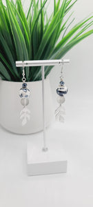 Length: 3 inches | Weight: 0.5 ounces  Distinctly You! These earrings are made with 14mm charcoal, white ceramic beads, 10mm frosted grey glass beads, 4mm charcoal faceted glass beads, silver leaf charms, and silver rondelles.