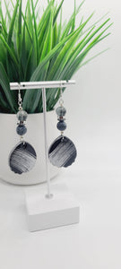 Length: 3.5 inches | Weight: 0.7 ounces  Distinctly You! These earrings are made with black and silver brushed teardrop-shaped polymer clay, 10mm black and white crackle glass beads, 10mm grey clear glass, silver and  Hematite rondelles.