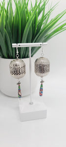 Length: 4 inches | Weight: 0.8 ounces  Distinctly You! These earrings are made with ethnic print wooden charms, large silver lanterns, and silver rondelles.