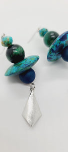Length: 3 inches | Weight: 0.6 ounces  Distinctly You! These earrings are made with multi-colored blue polymer clay saucers, 10mm blue Druzy stones, 12mm green Tiger Eye stones, 6mm green faceted glass stones, and silver diamond-shape charm.